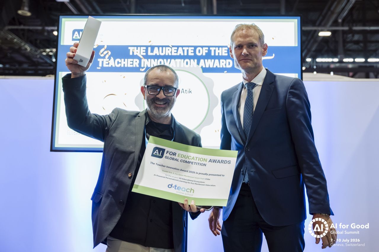 An award recipient raising a trophy beside another participant at the Global AI for Education Awards, Geneva 2026