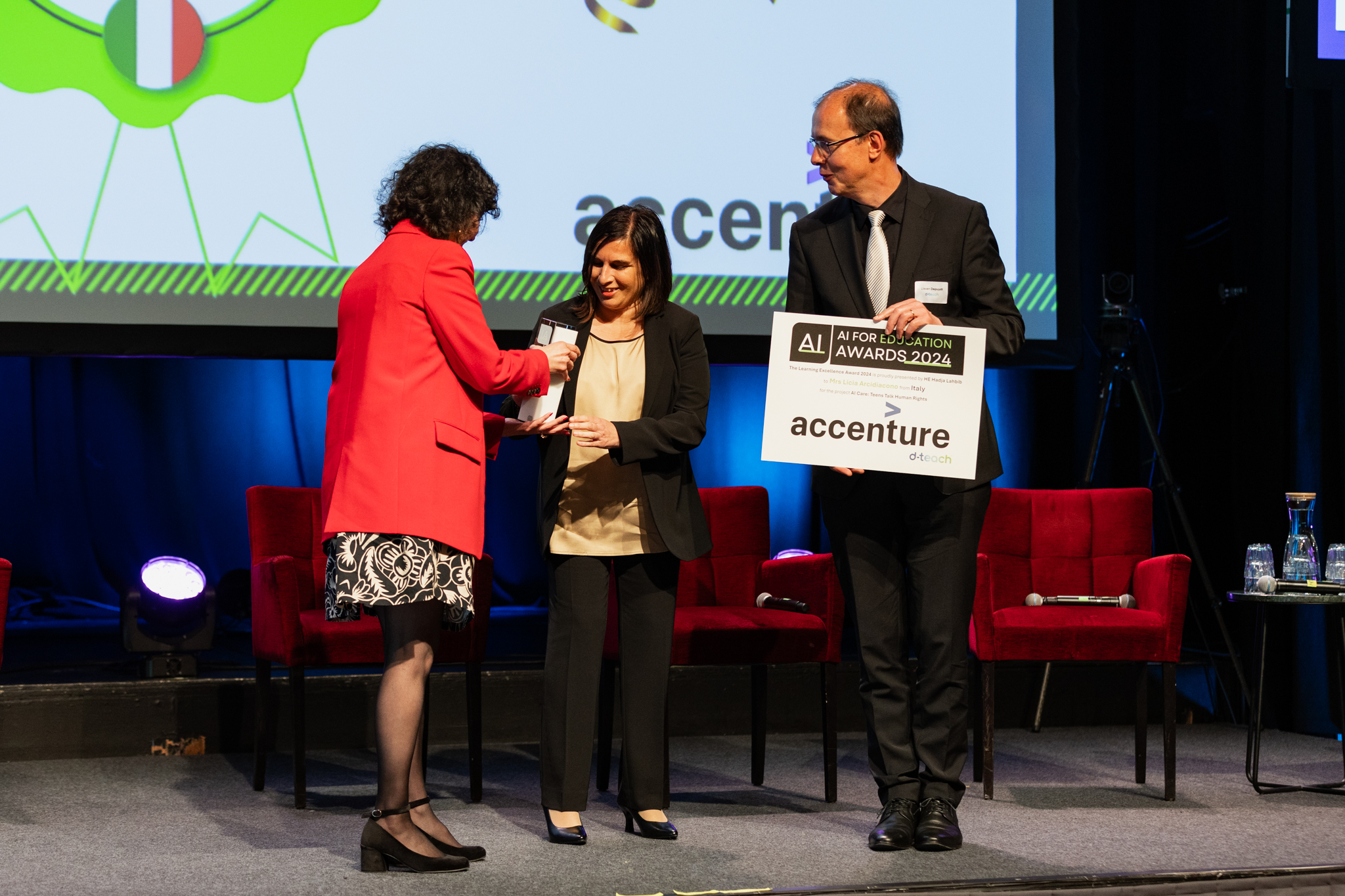 An award being handed to a recipient on stage at the AI for Education Awards in Oslo in 2024